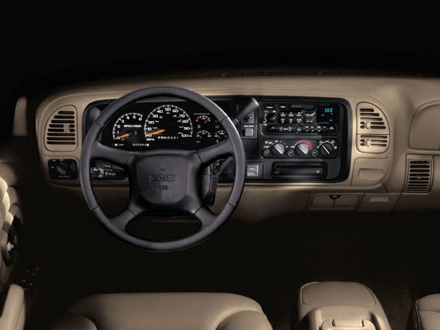 Classic 1990s SUV dashboard with steering wheel and instrument panel