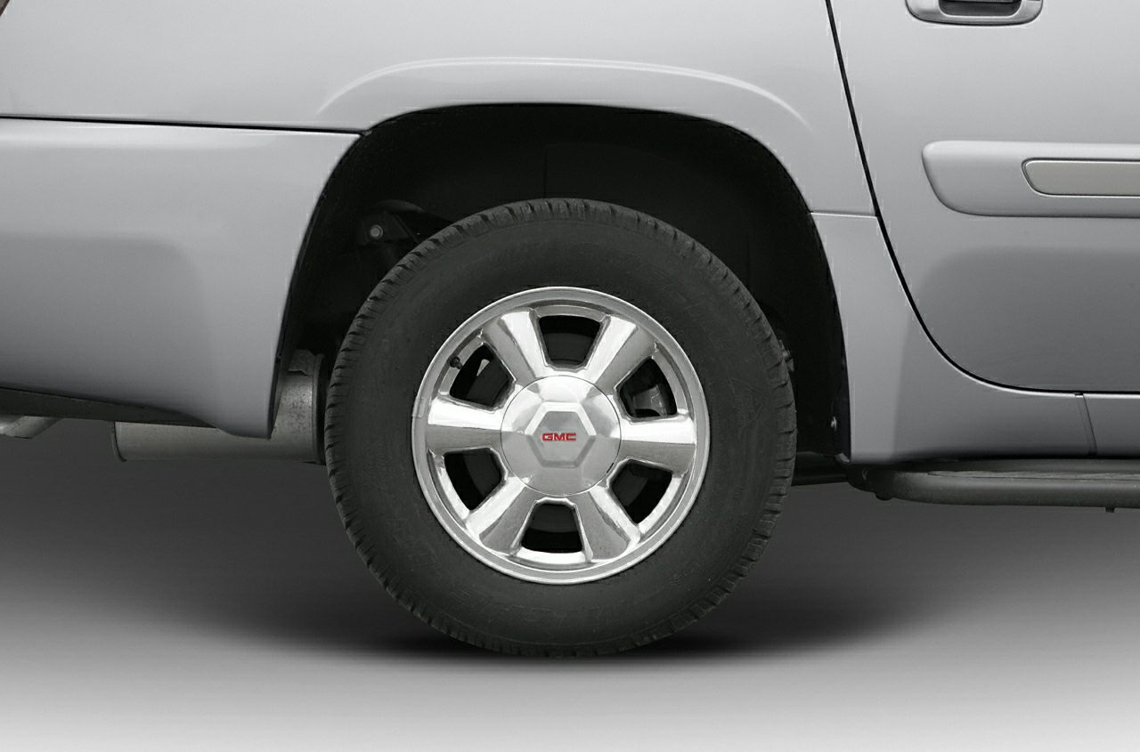 Close-up of a wheel and side panel with alloy rim and tire.