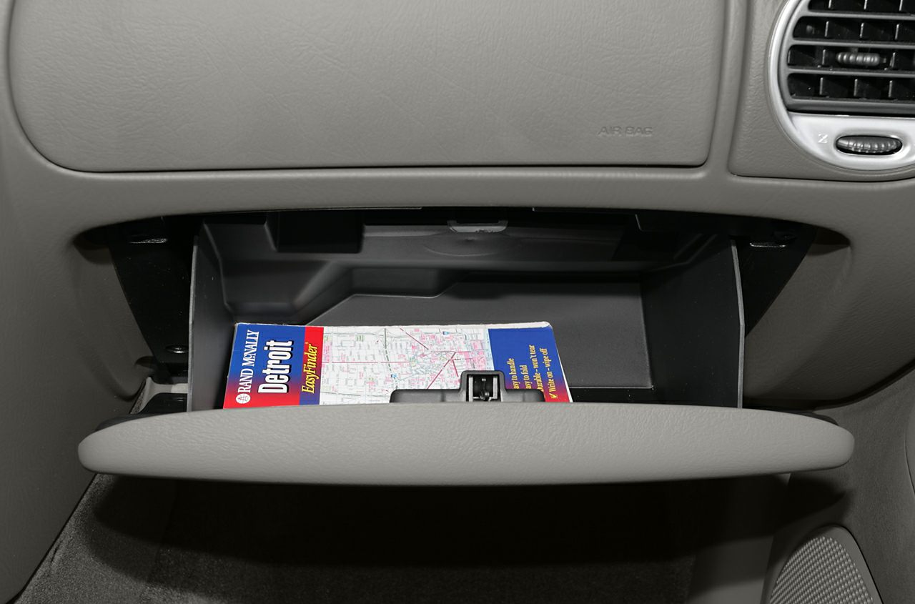 Open glove compartment with storage space inside vehicle dashboard