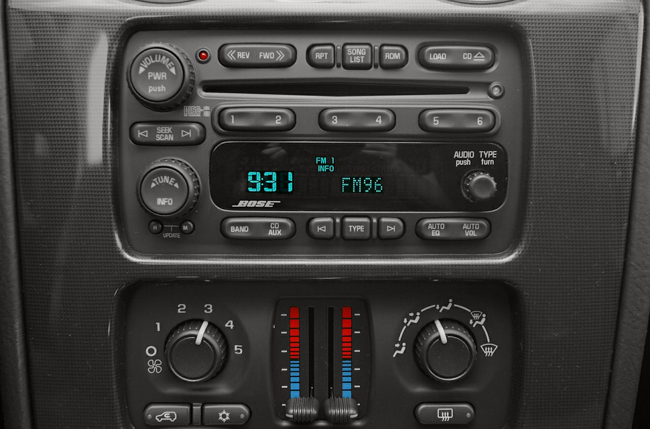 Stereo system with Bose audio and climate control panel with temperature sliders and fan dial