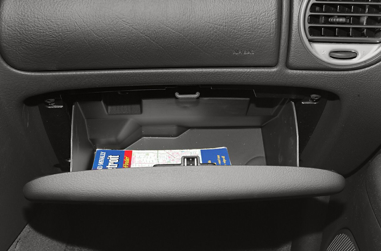 Open glove box storage compartment inside vehicle dashboard
