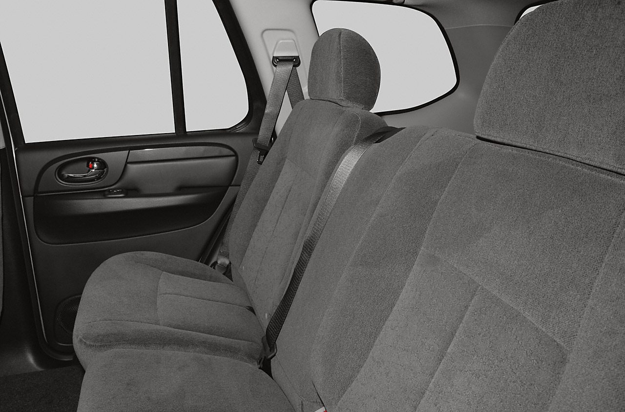 Rear passenger seats with cloth upholstery and seat belts.