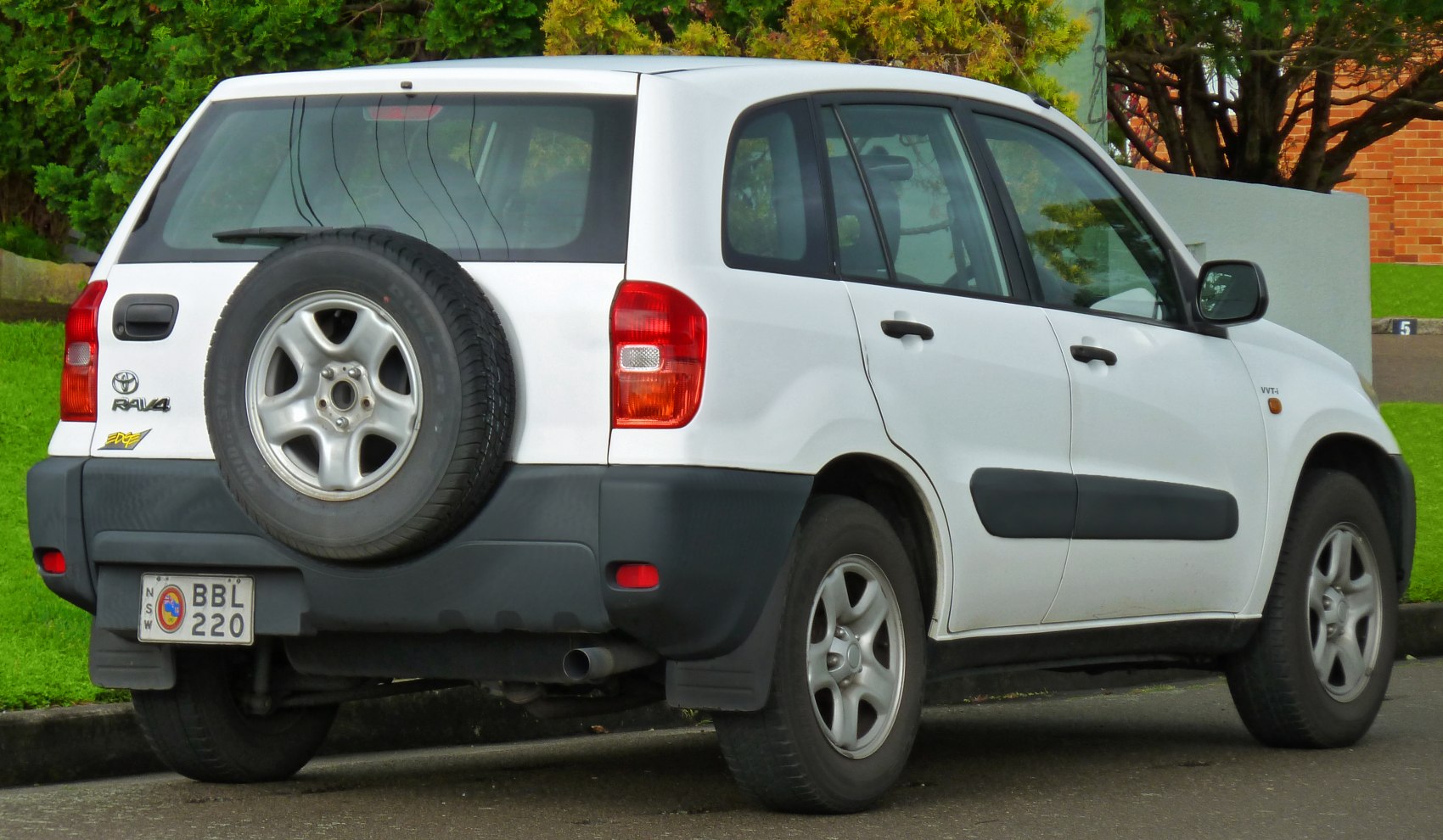 Rear view with tailgate-mounted spare wheel and black bumper details