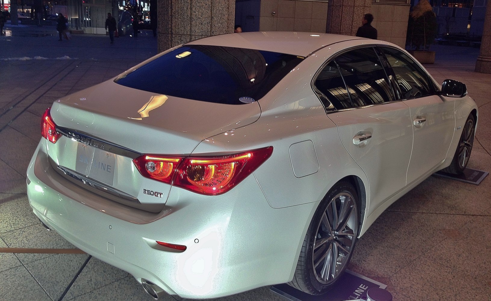 Rear and side view of sedan with LED tail lights and alloy wheels