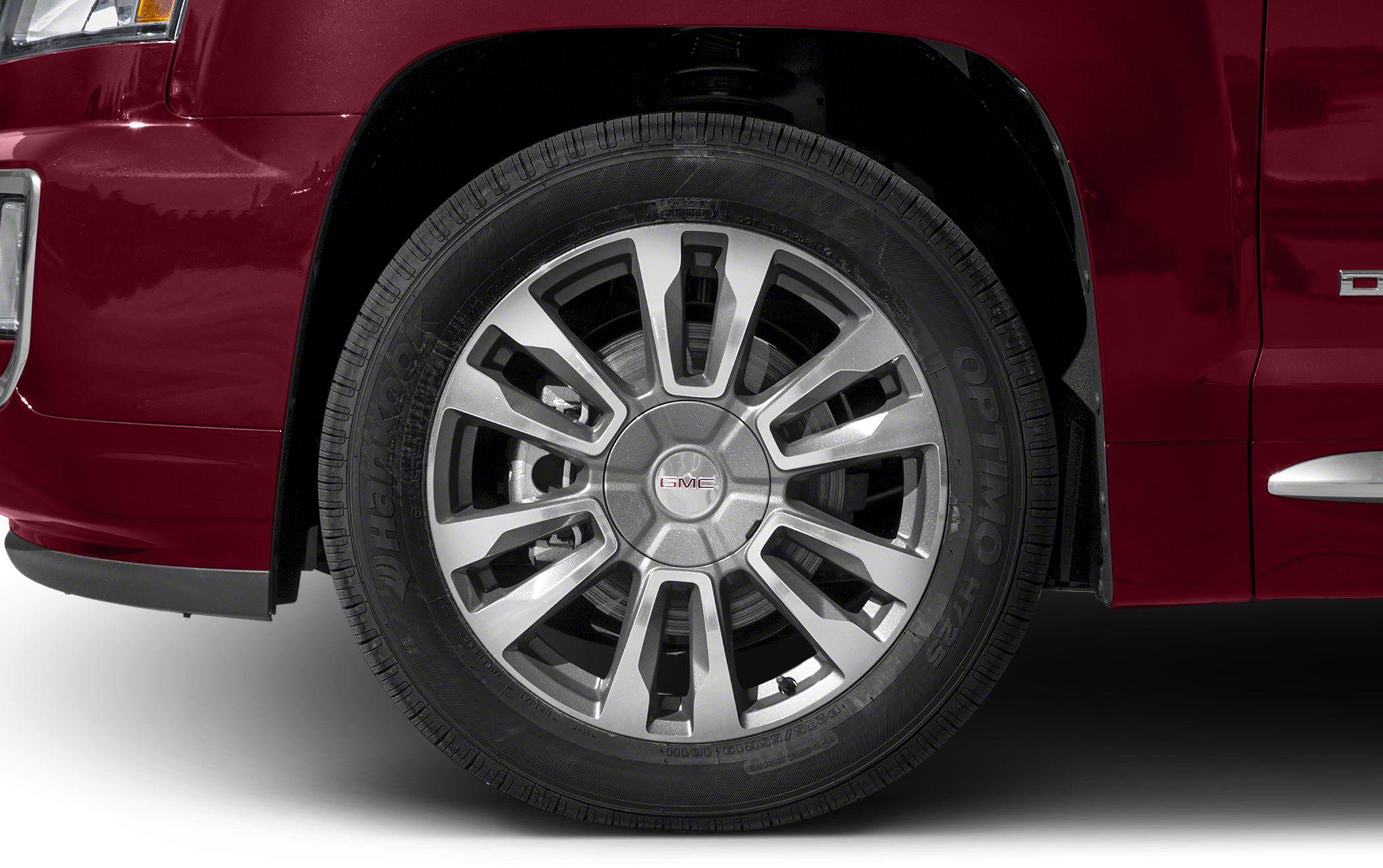 Close-up of alloy wheel and tire on red SUV