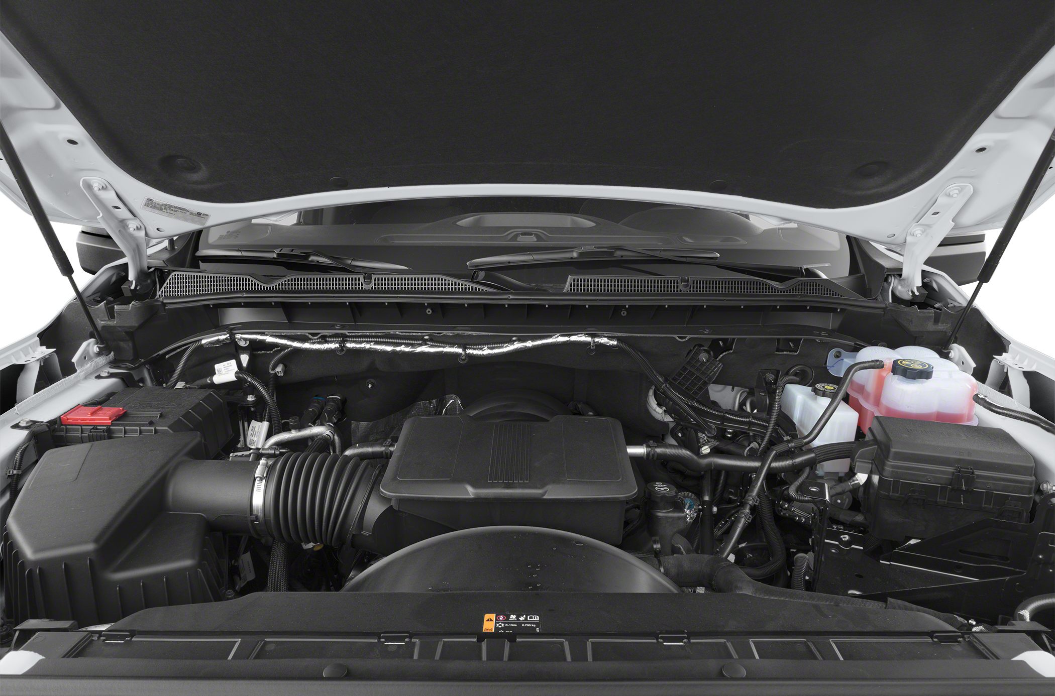Open engine compartment with modern components and fluid reservoirs.