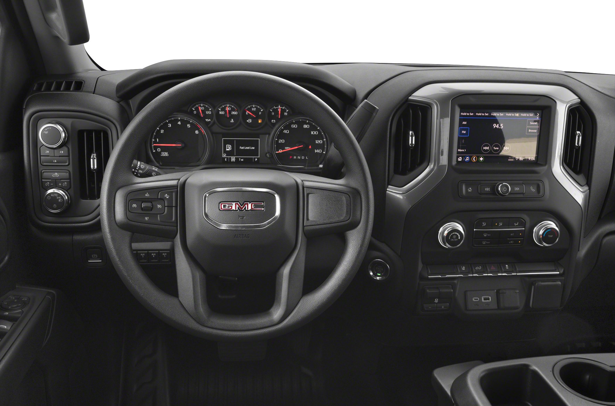 Dashboard and steering wheel with infotainment screen and analog gauges