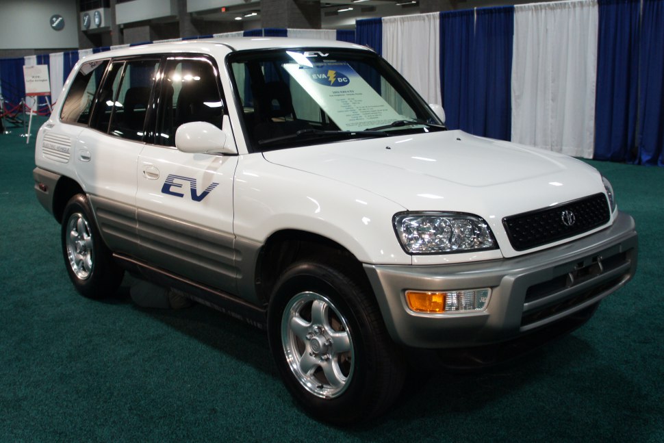 Front side view of a 1997 electric SUV with EV logos and two-tone paint.