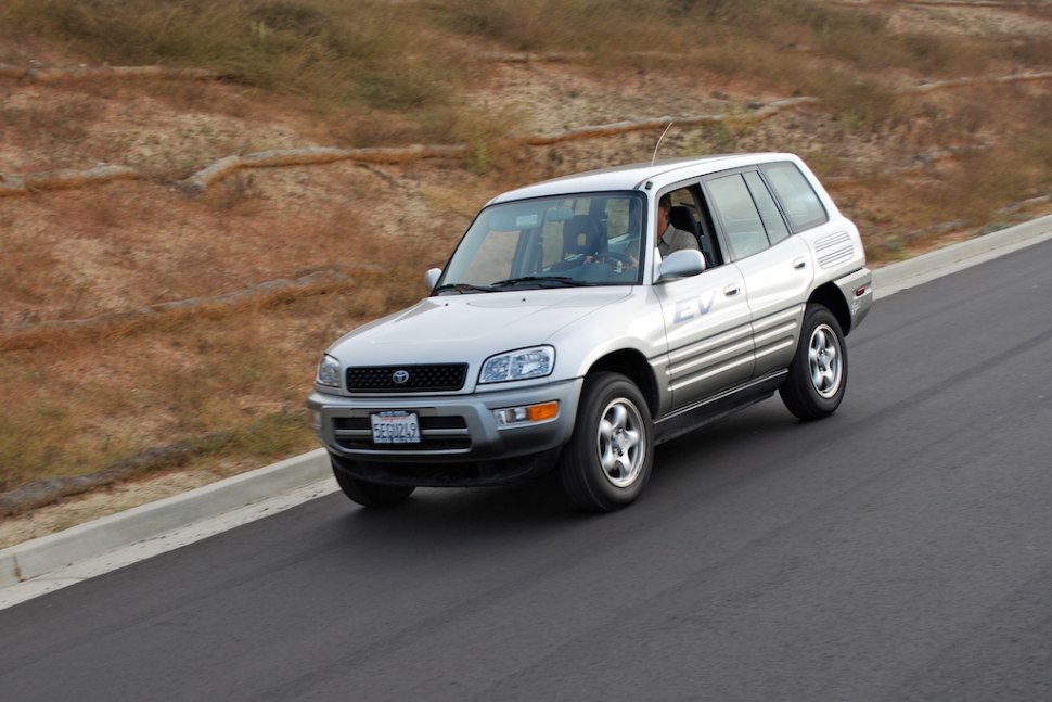 Silver 5-door electric SUV driving on paved road