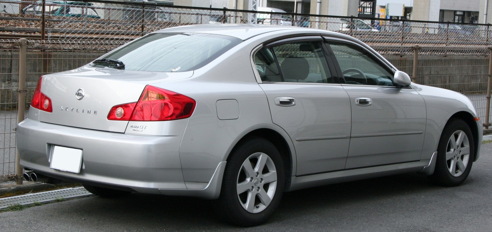 Rear side view of silver sedan showing distinctive taillights and alloy wheels