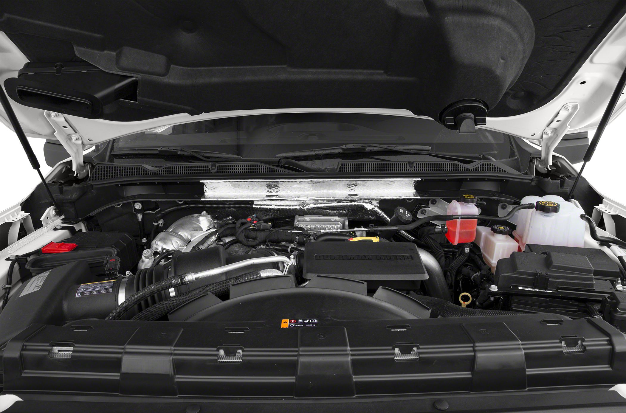 Duramax 6.6L diesel engine compartment with protective covers and fluid reservoirs