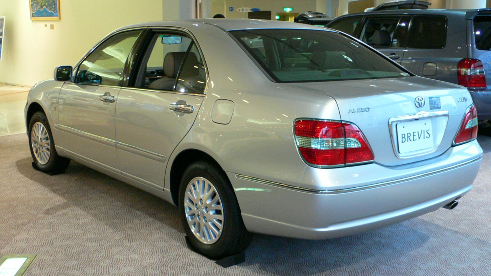 Rear view of mid-size sedan with distinctive taillights and alloy wheels