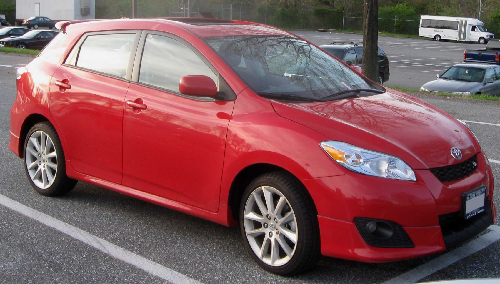 Red hatchback with alloy wheels and sporty front side view
