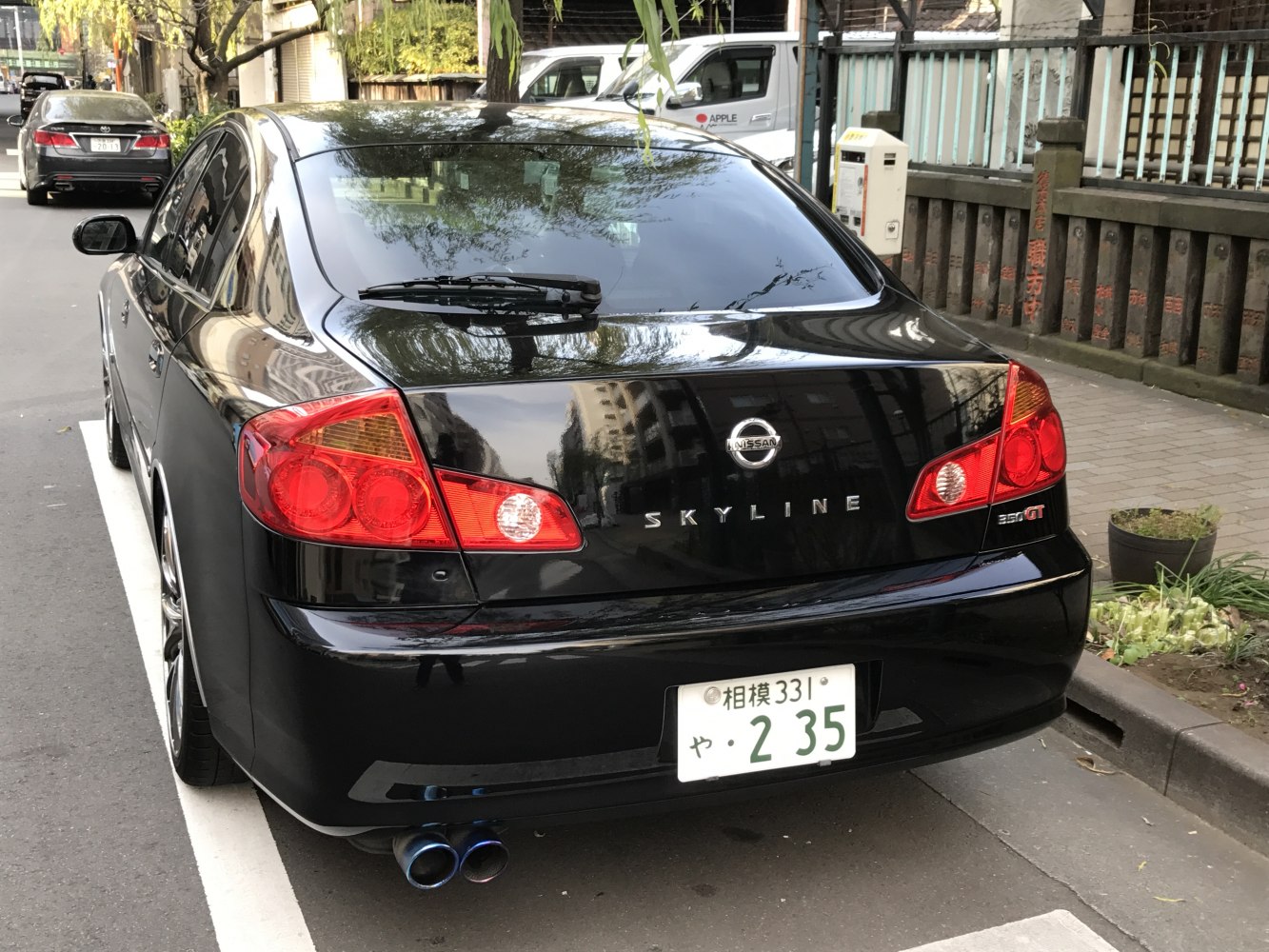 Rear view with distinctive tail lights and quad exhaust