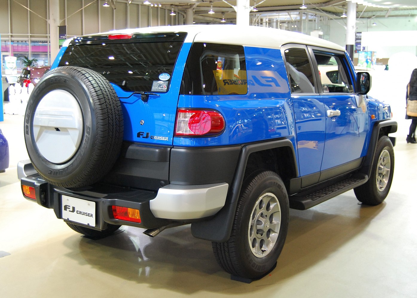 Rear view with mounted spare tire and white roof