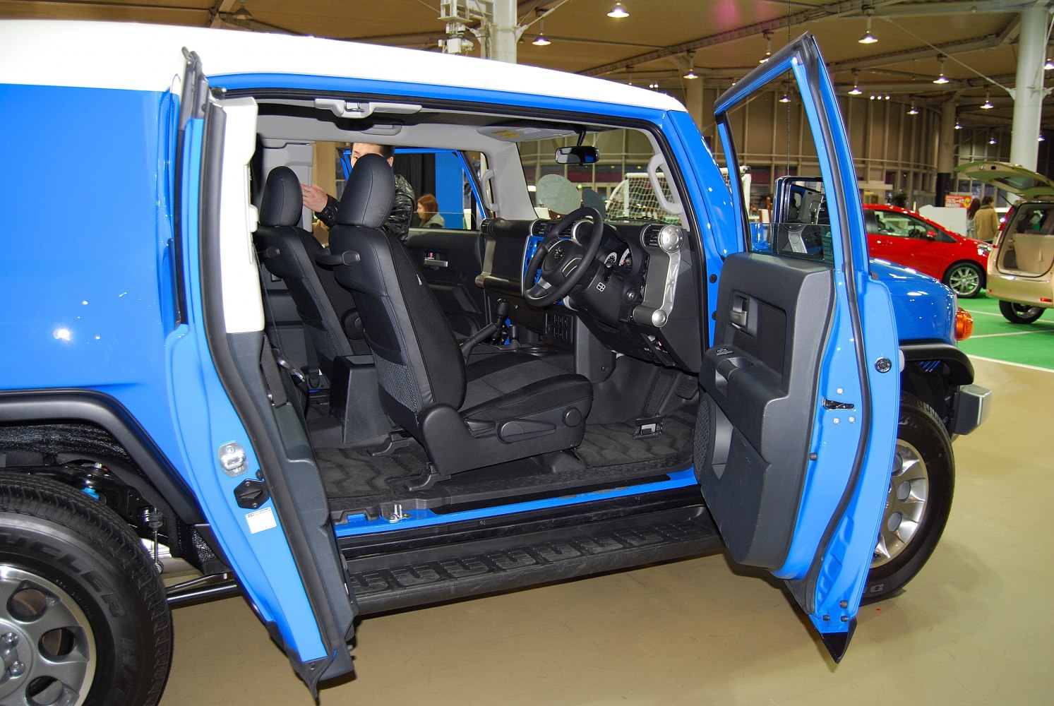 Open front doors showing black interior seats and dashboard of SUV.