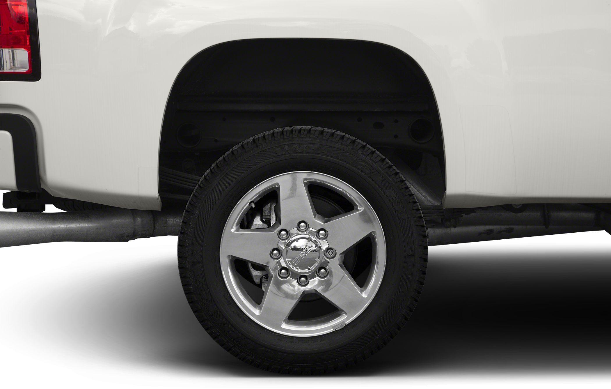 Polished five-spoke alloy wheel and tire with visible suspension and exhaust