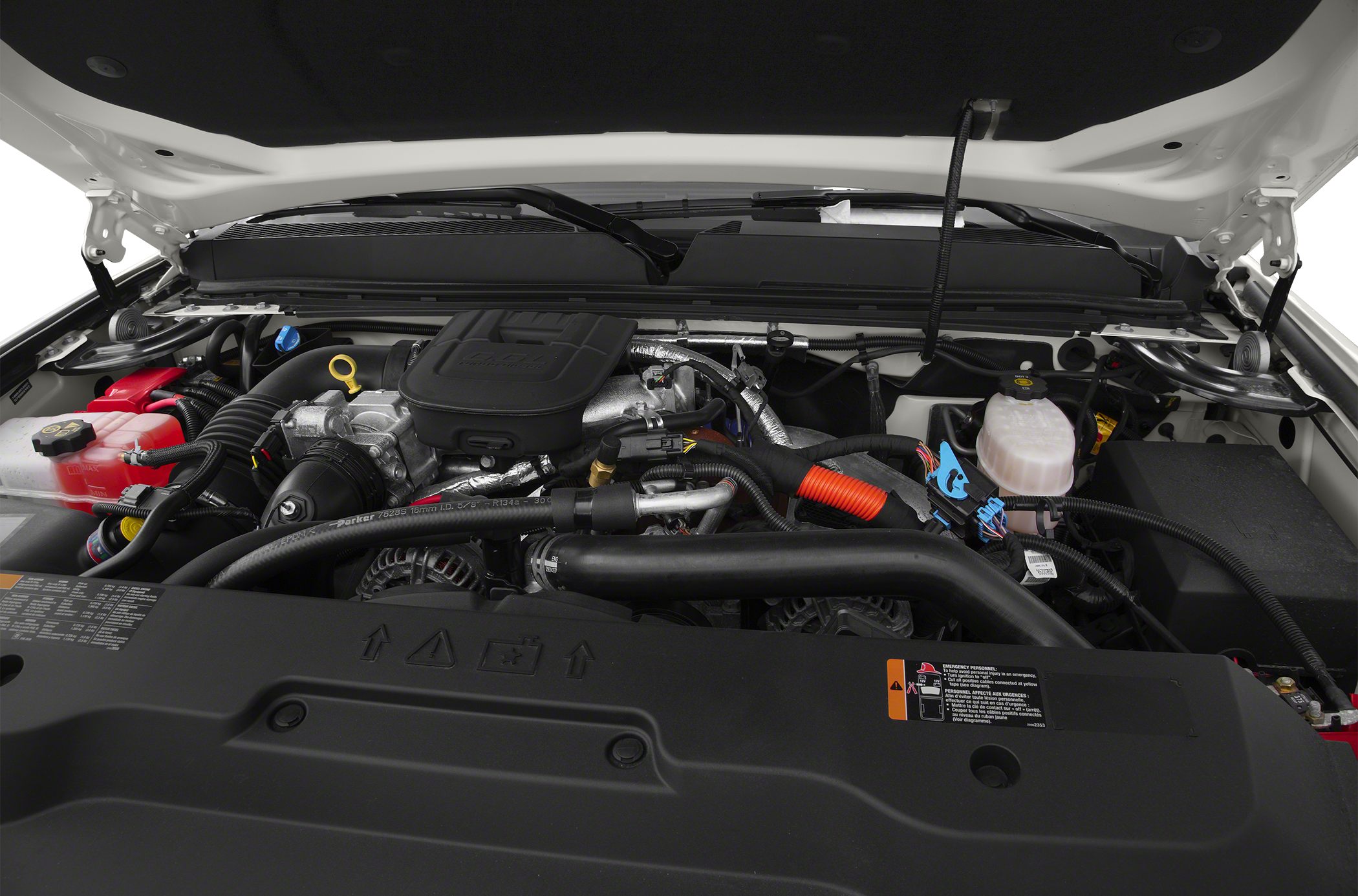 Engine compartment close-up with hoses, reservoir tanks, and mechanical details