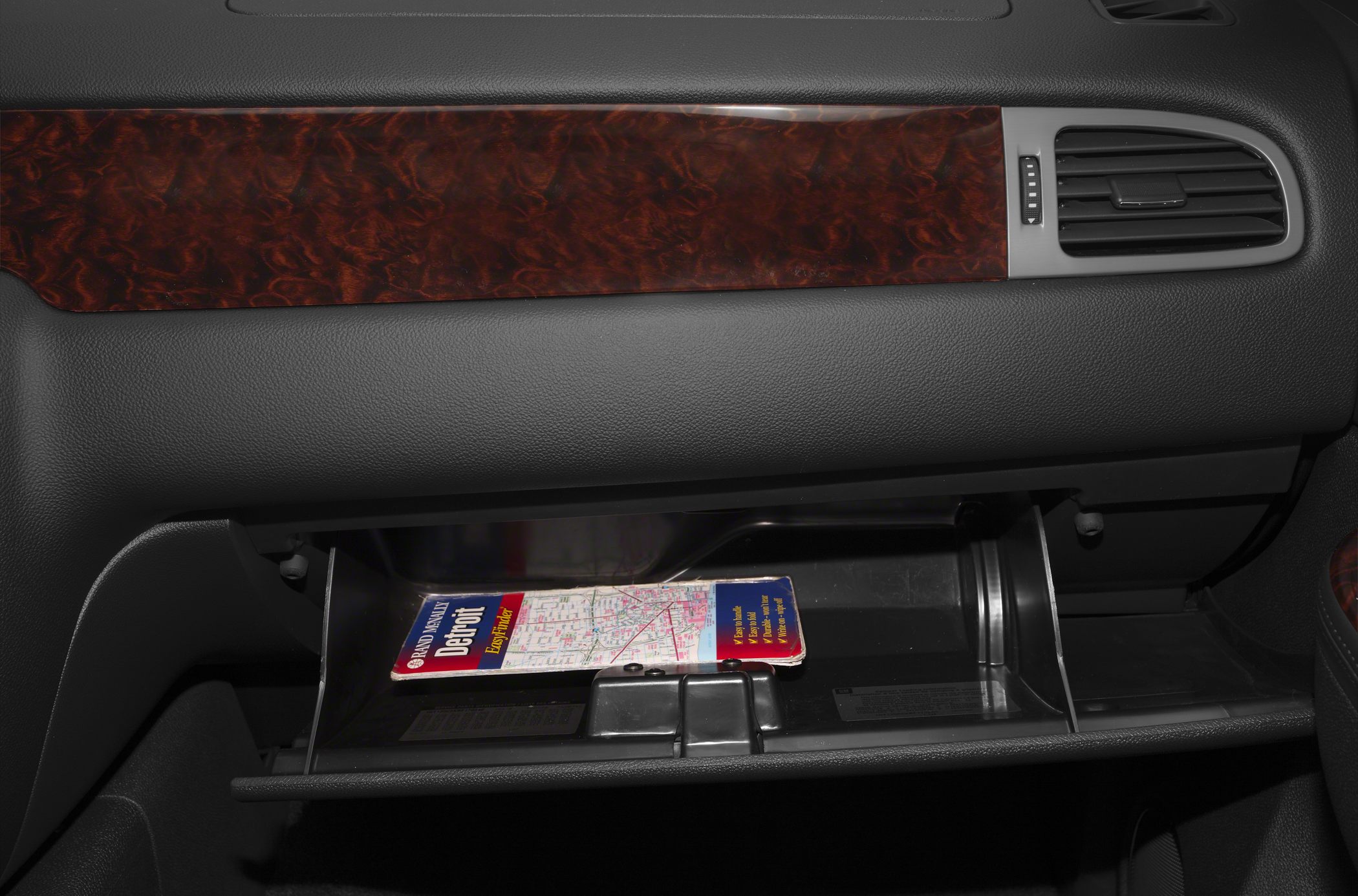 Glove compartment with map and wood grain dashboard trim