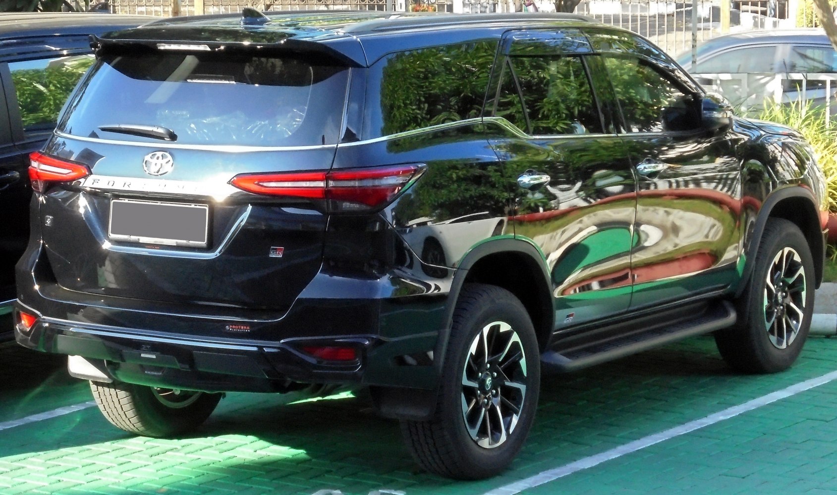 Rear and side view of black SUV with tail lights and alloy wheels