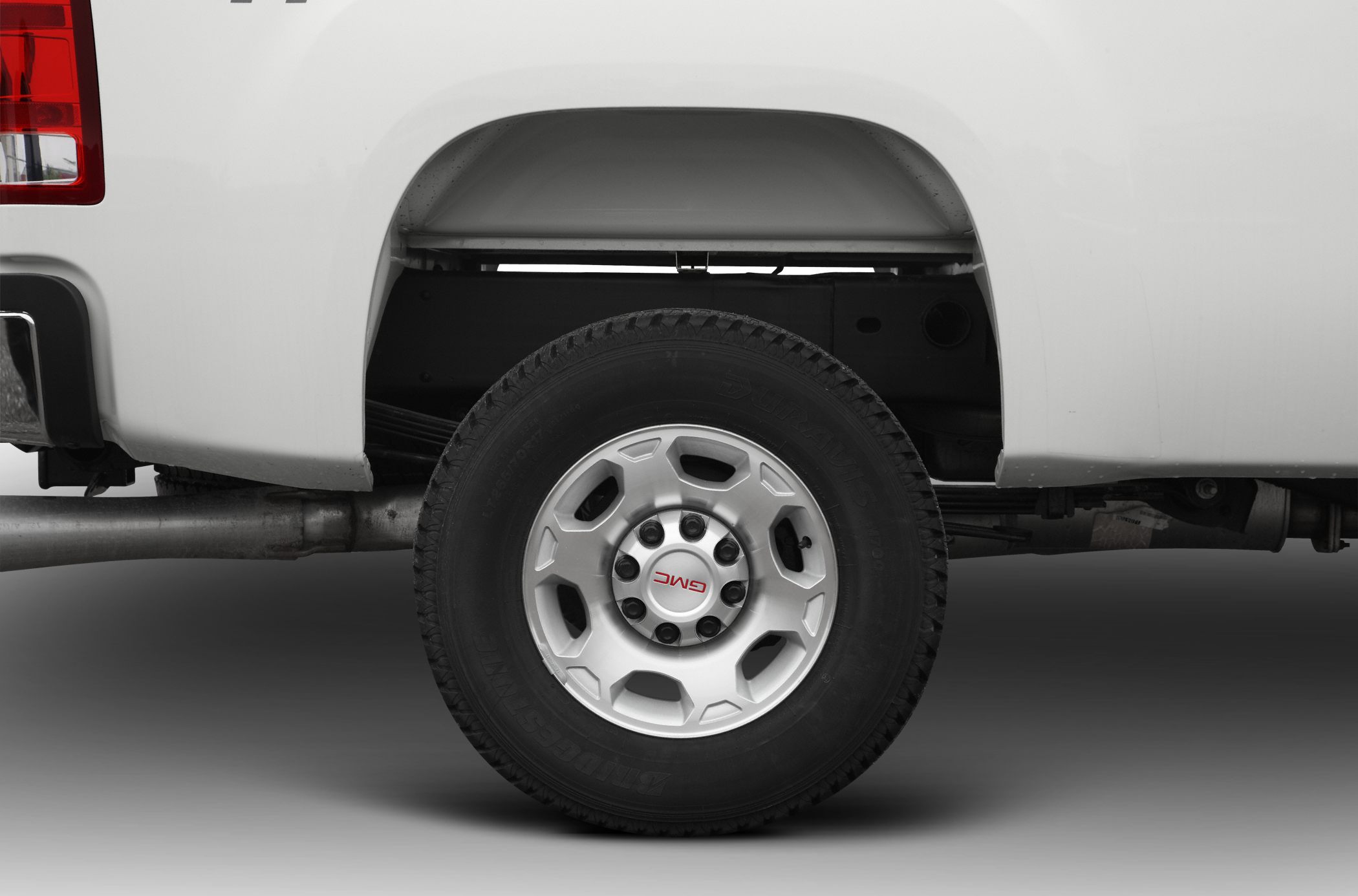 Rear wheel with Bridgestone tire and leaf spring suspension detail.
