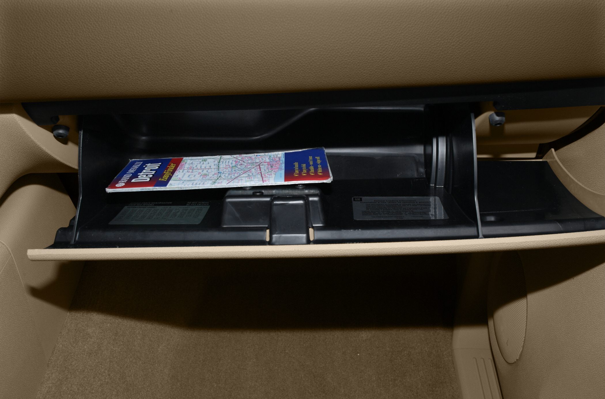 Open glove compartment with map inside a vehicle