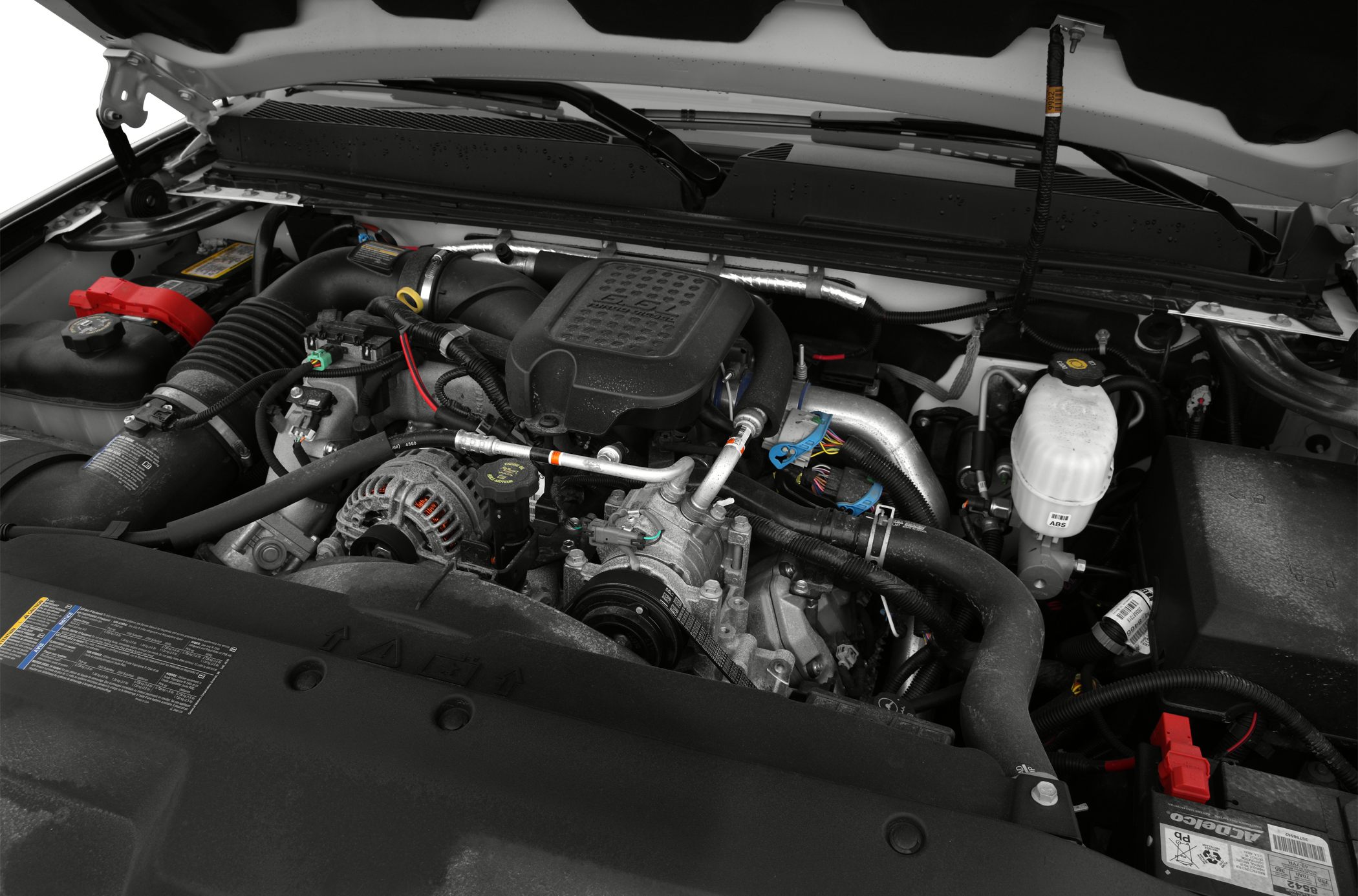 Engine bay with V8 engine, air intake, alternator, battery, and mechanical components