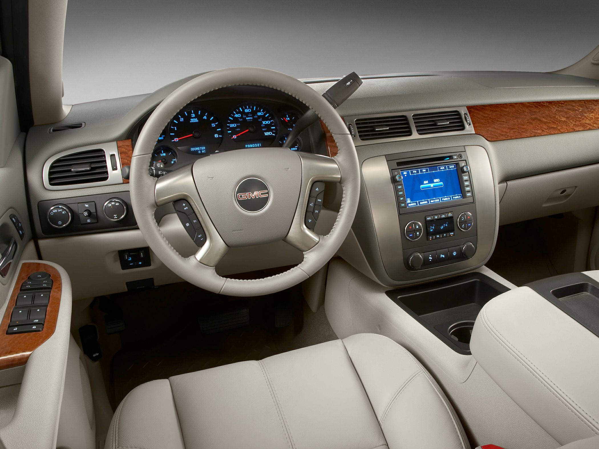 Dashboard, steering wheel with controls, wood trim interior