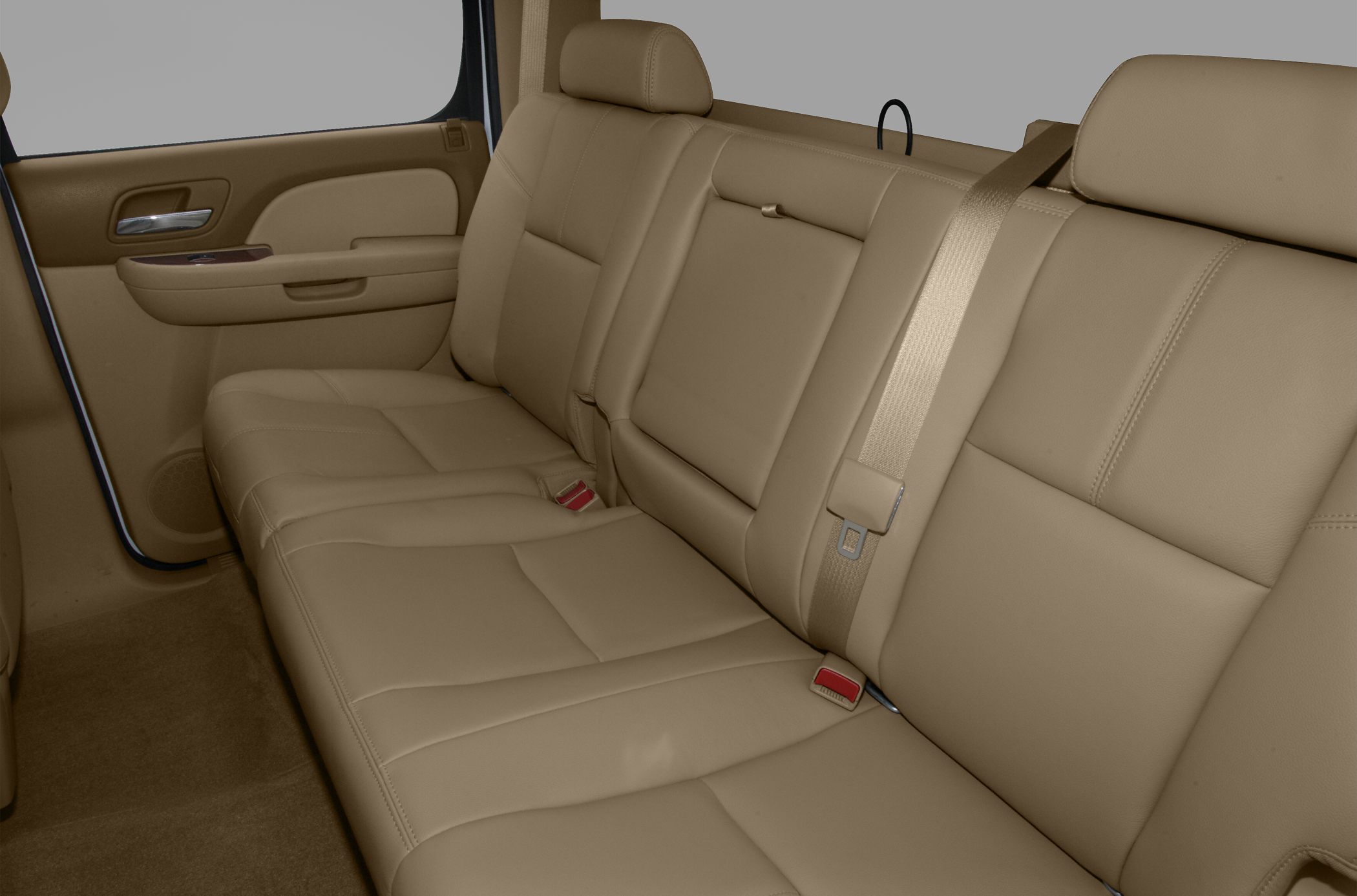 Tan leather rear seat with integrated seatbelts and headrests