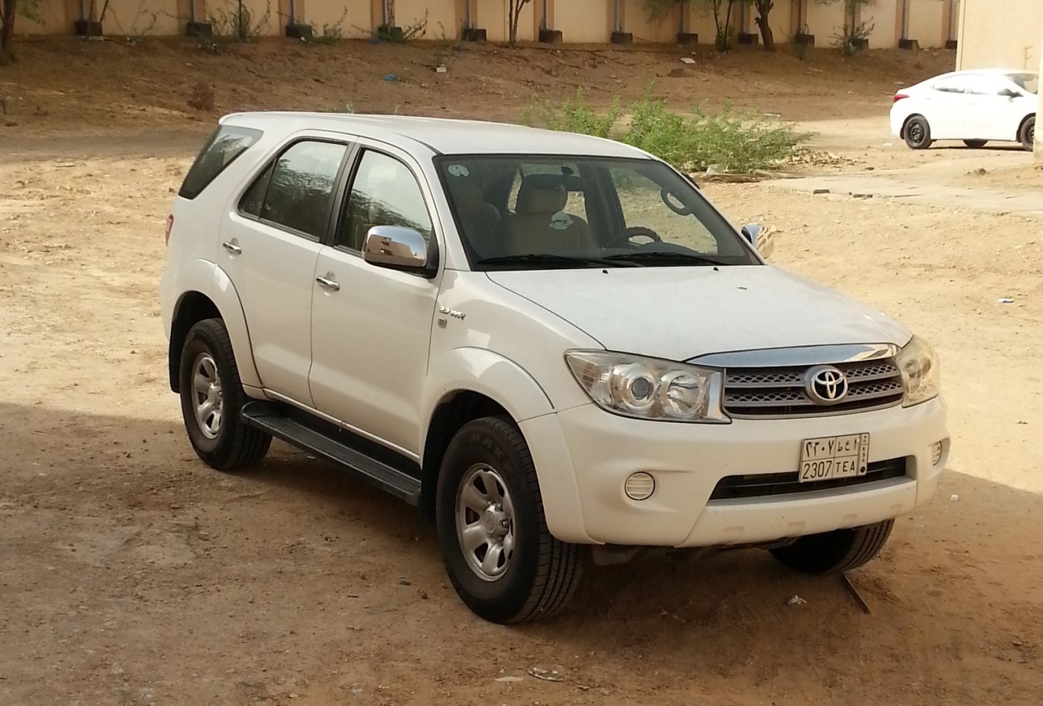 Front side view of an SUV with distinct headlights and grille.