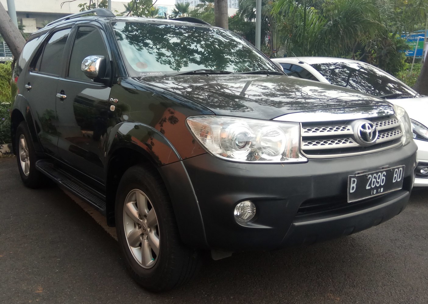 Front side view showing chrome grille and headlights of SUV