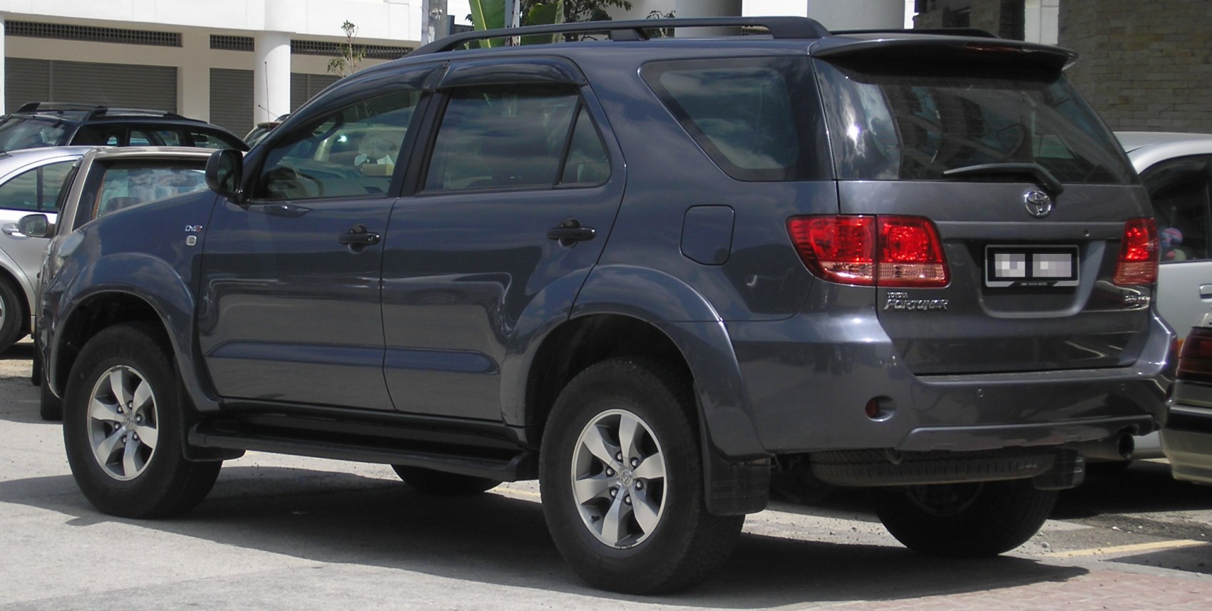 Rear side view of a robust SUV with alloy wheels and tinted windows