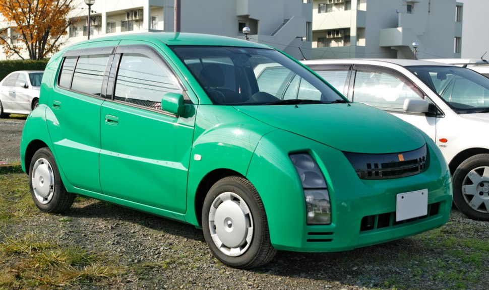Retro compact hatchback with unique vertical headlights and smooth curved body panels
