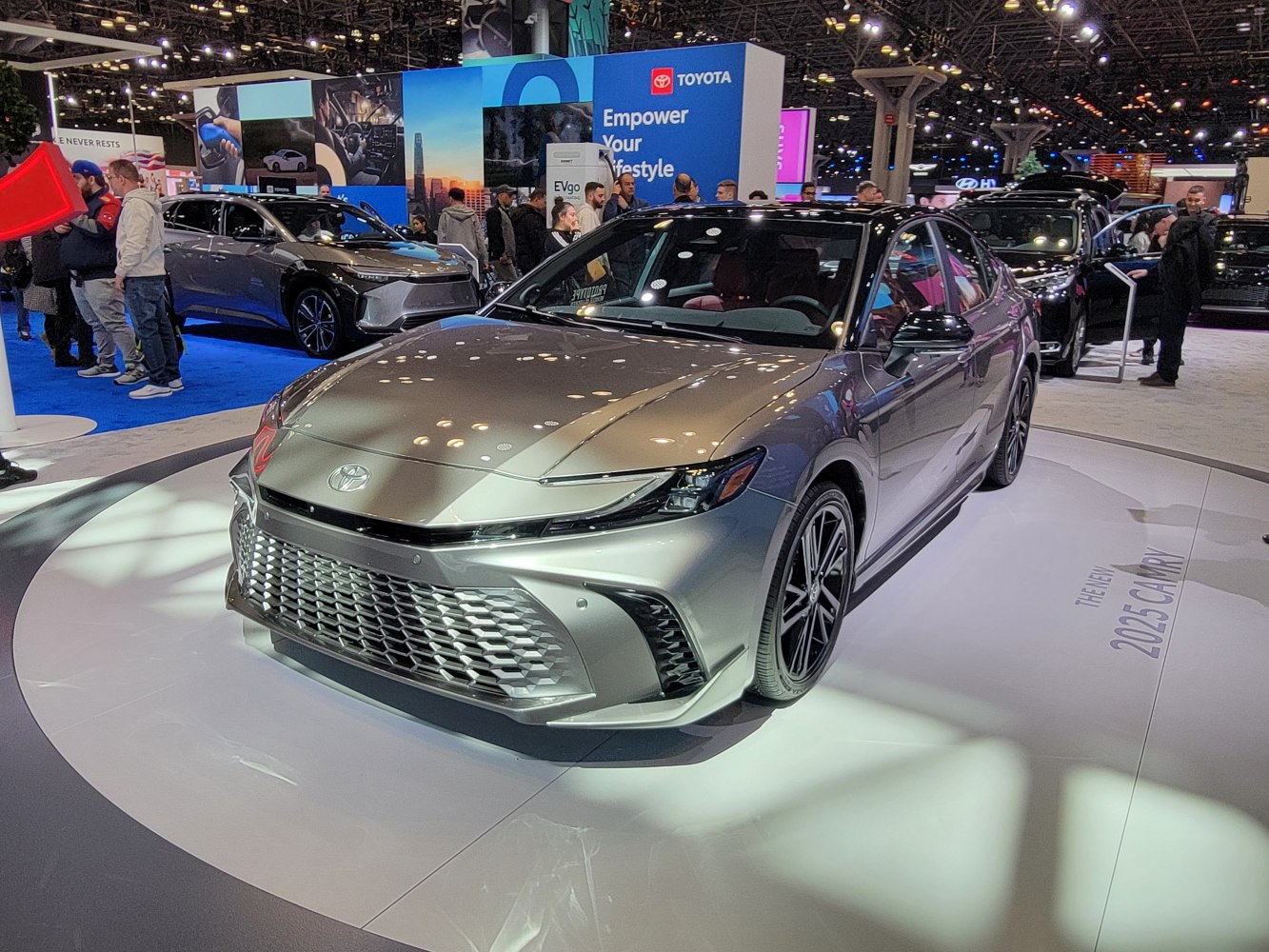 Front view of a sleek modern sedan with bold grille and sharp headlights