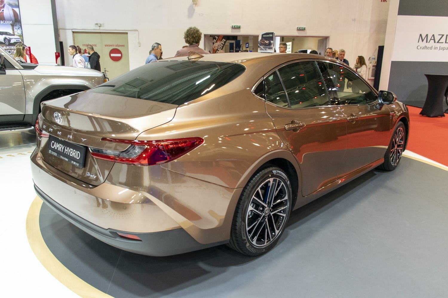 Rear view of hybrid sedan with sleek tail lights and alloy wheels