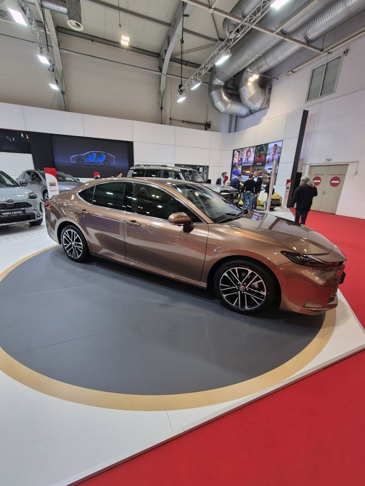 Side view of a sleek modern sedan with stylish alloy wheels.