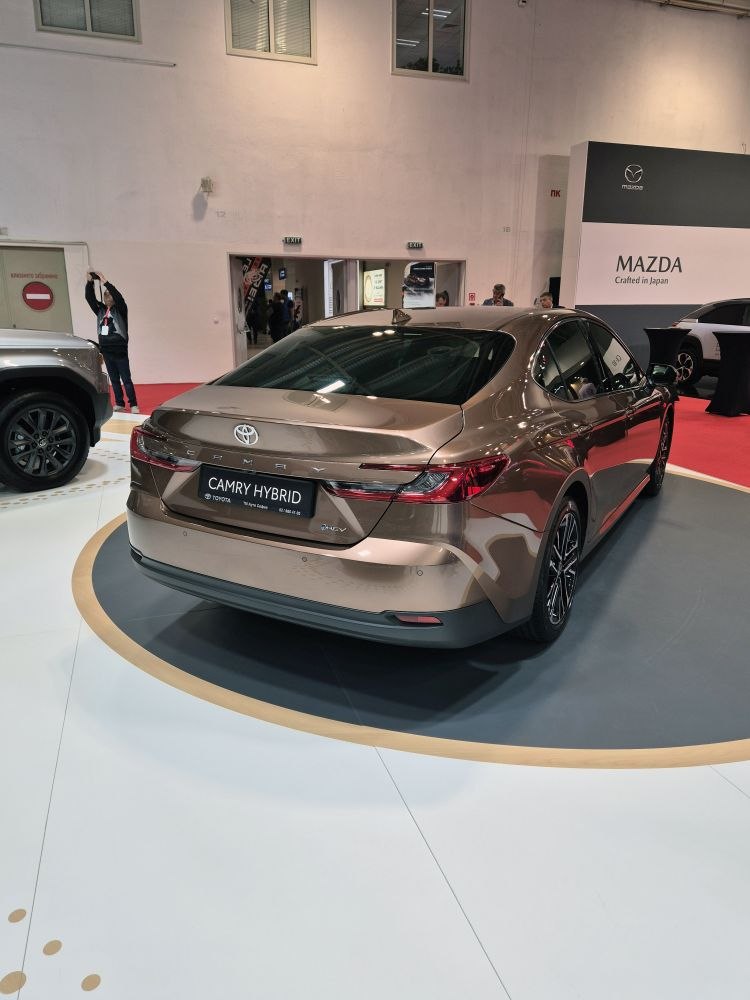 Sleek rear view with sharp tail lights and alloy wheels