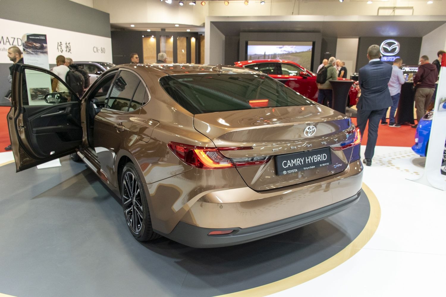 Rear view of sleek modern sedan with LED tail lights and open door