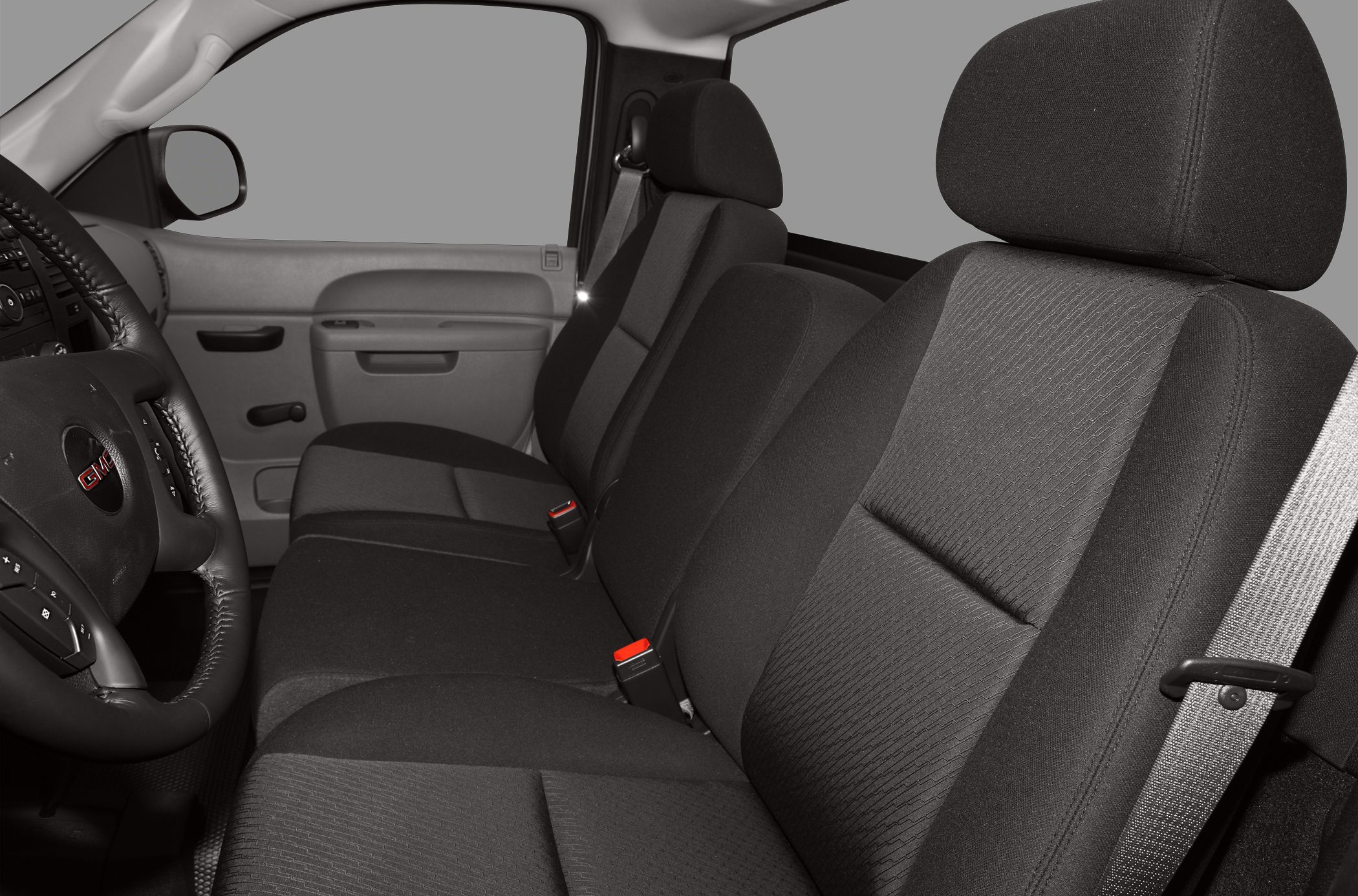 Front cloth bench seat and steering wheel with controls in truck interior
