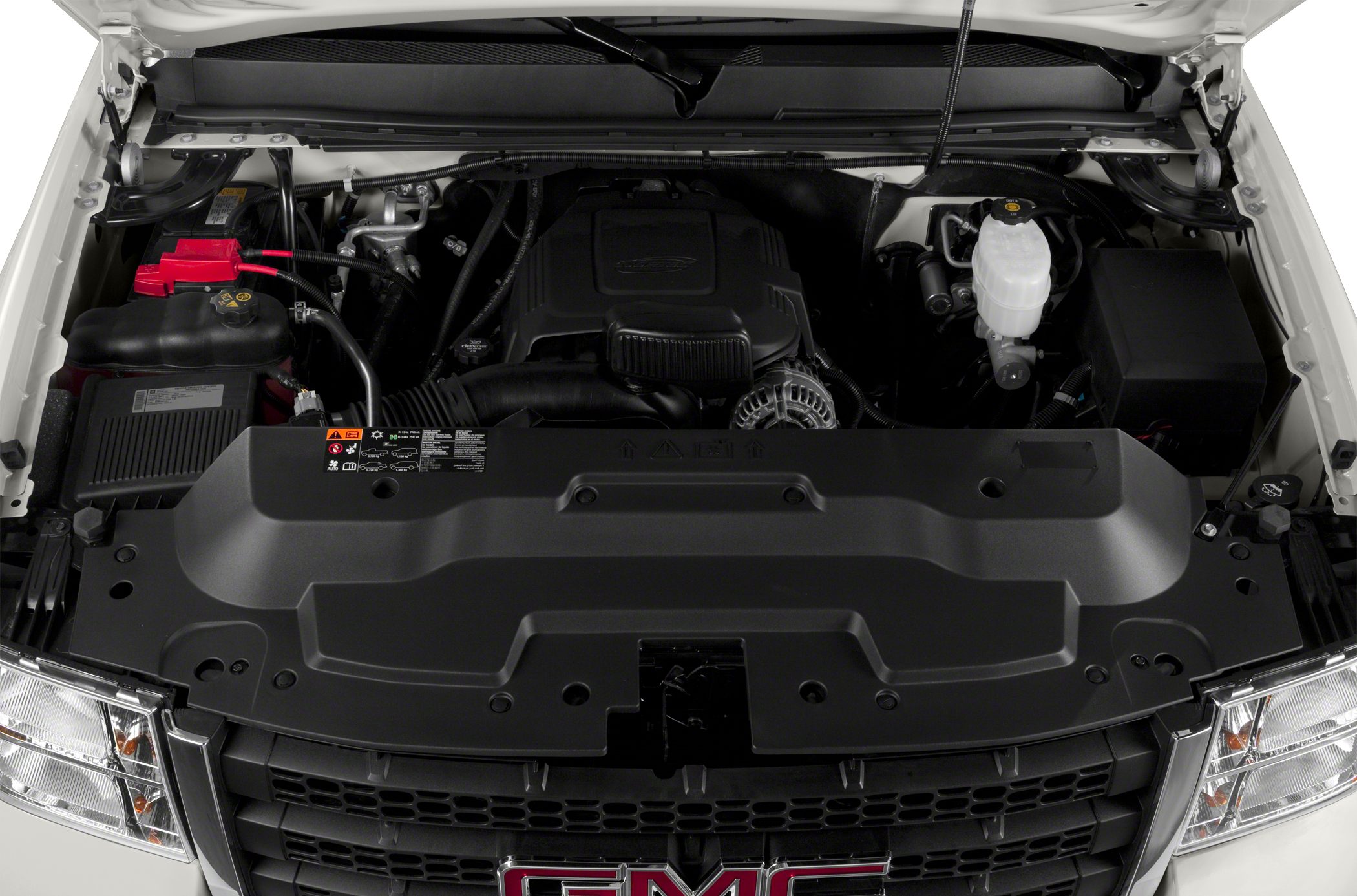 Engine bay layout with visible components and cover in a heavy-duty pickup.