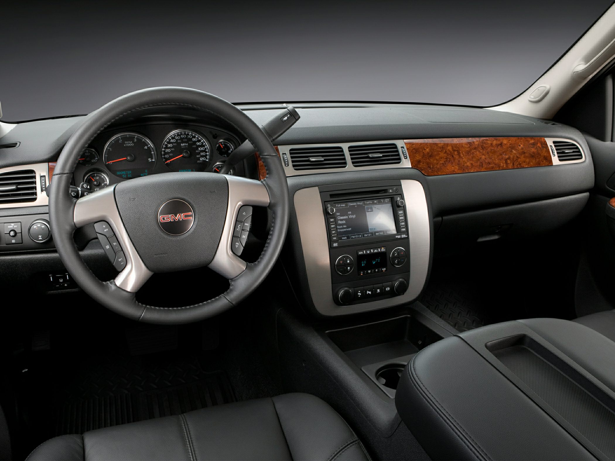 Dashboard and steering wheel with wood trim and integrated controls