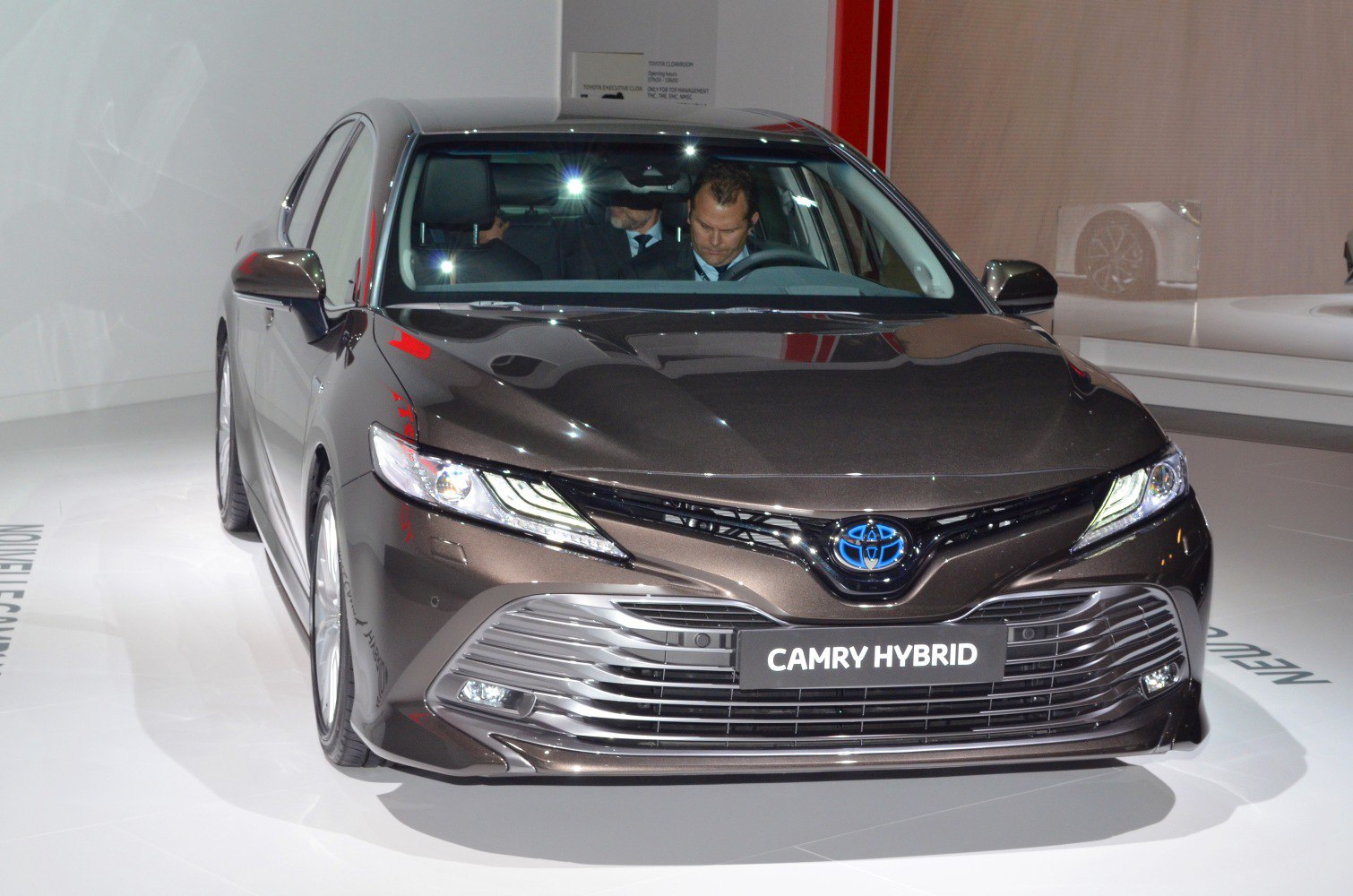 Front view of hybrid sedan with LED headlights and large grille