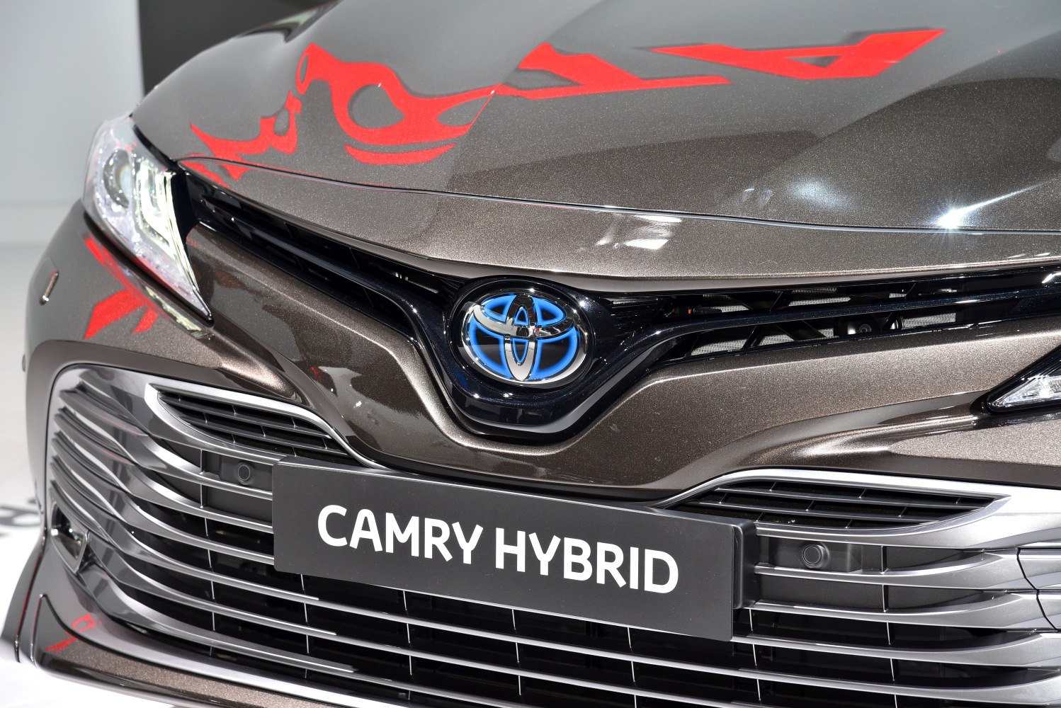 Close-up of hybrid front grille with Toyota emblem and badge