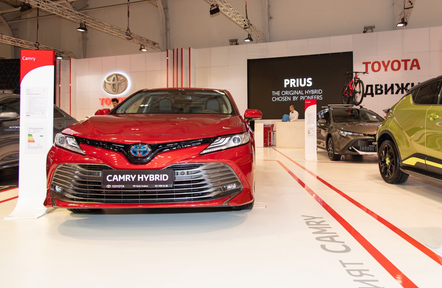 Front view of a hybrid sedan with sleek grille and sharp LED headlights