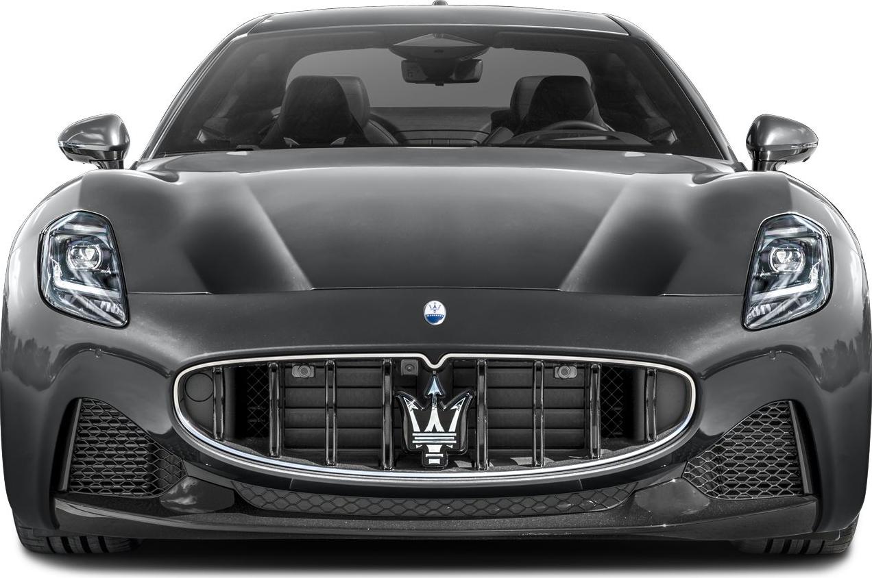 Front grille and sleek LED headlights with aerodynamic hood and twin seats visible inside.