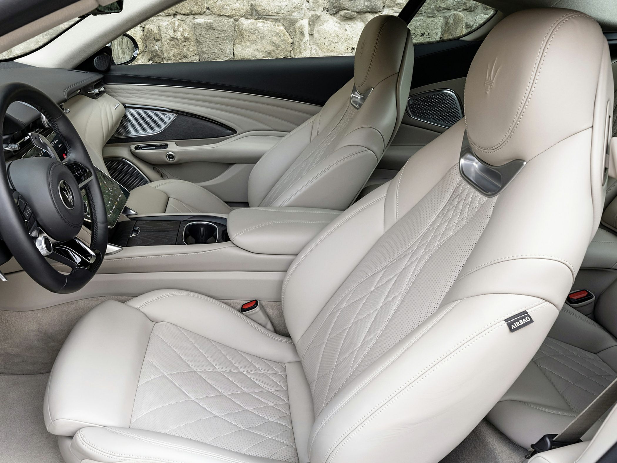 Beige leather seats with quilted design and premium car interior features