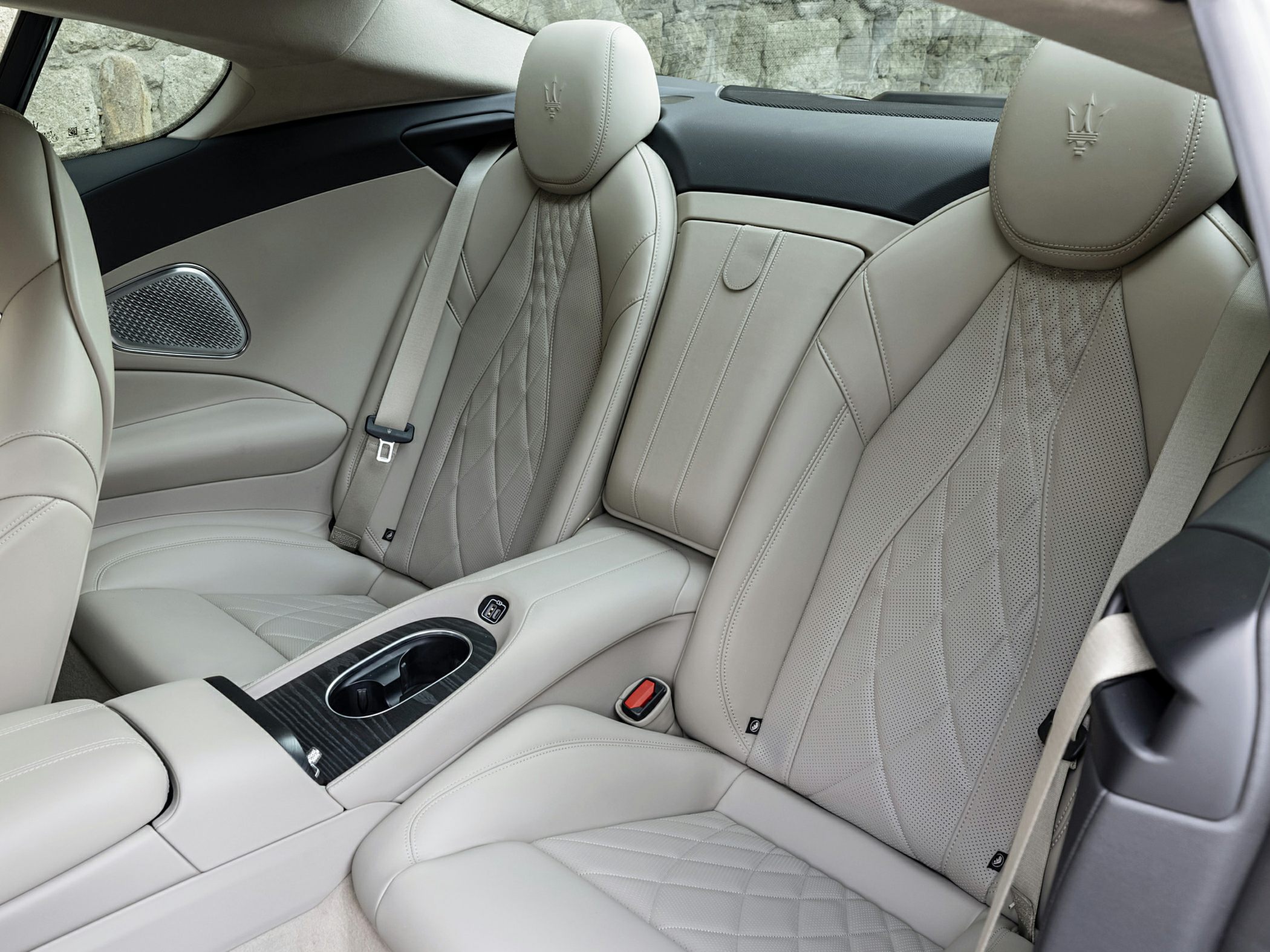 Rear leather seats with quilted pattern and center console cup holders.