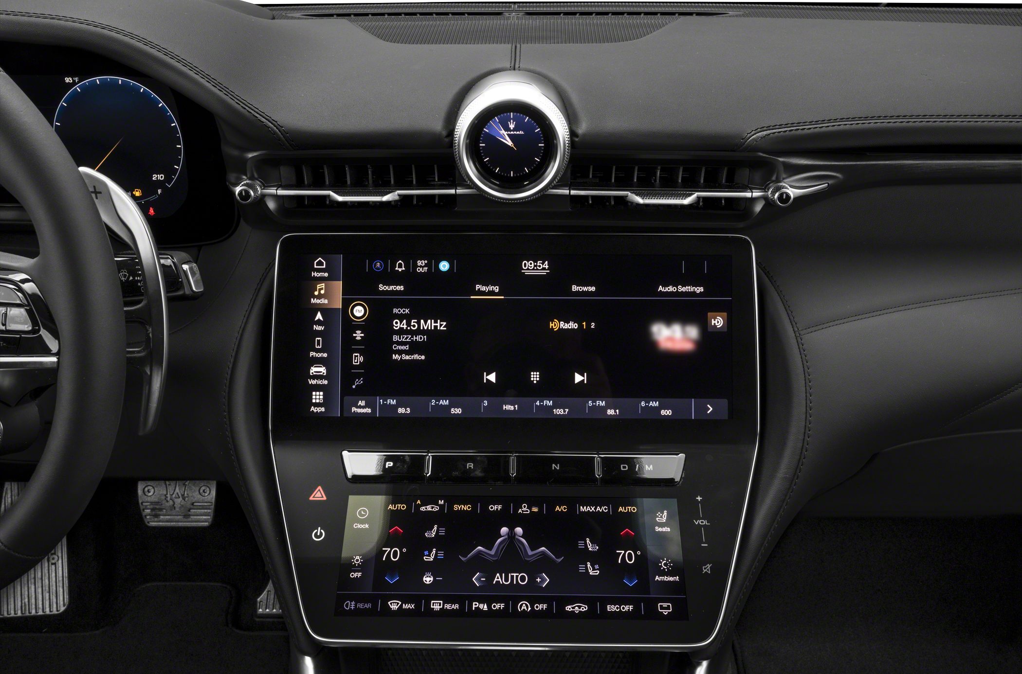 Dual touchscreen infotainment system with analog clock on luxury dashboard