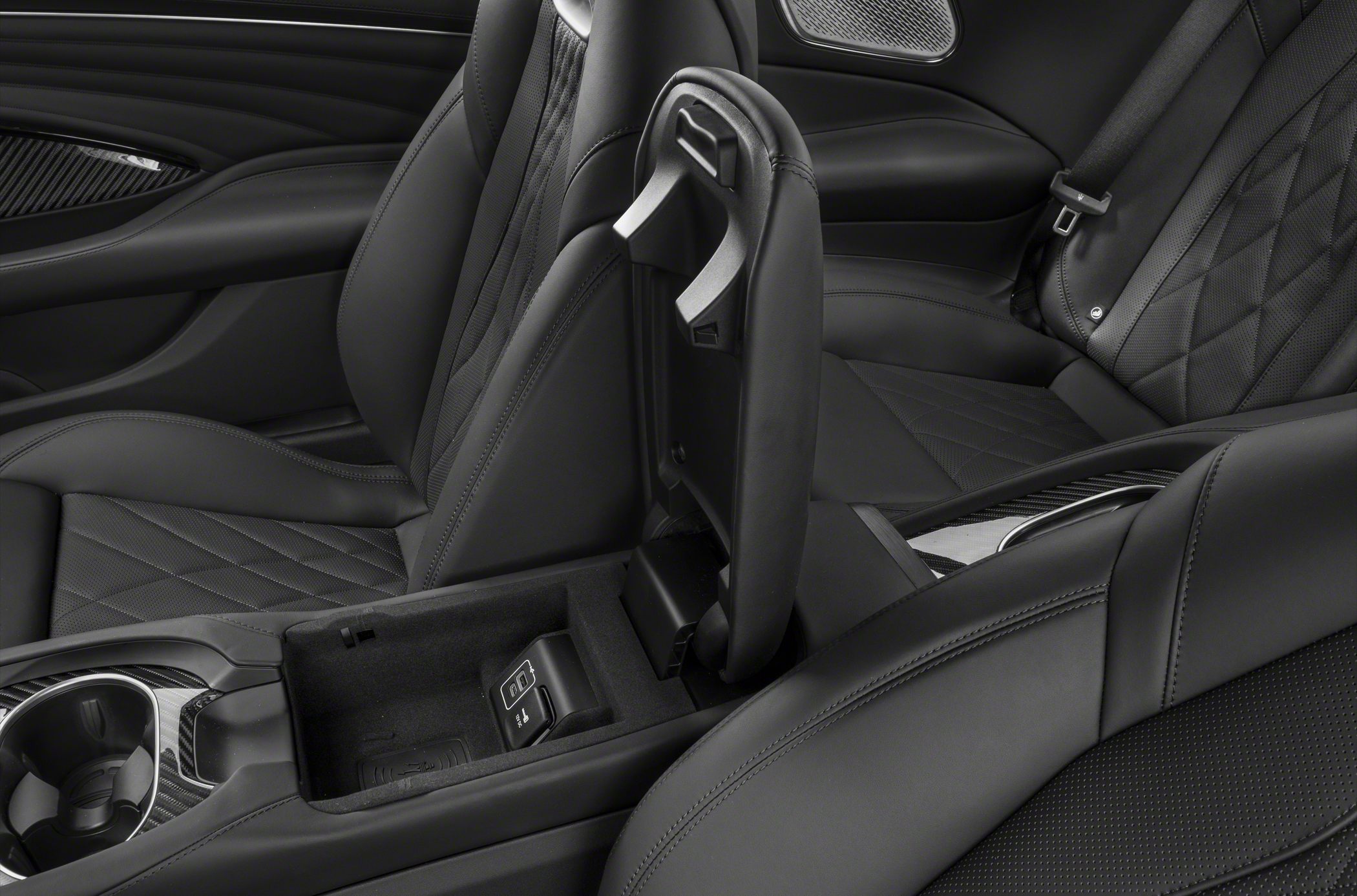 Luxurious black leather seats with quilted pattern and open center console with storage.