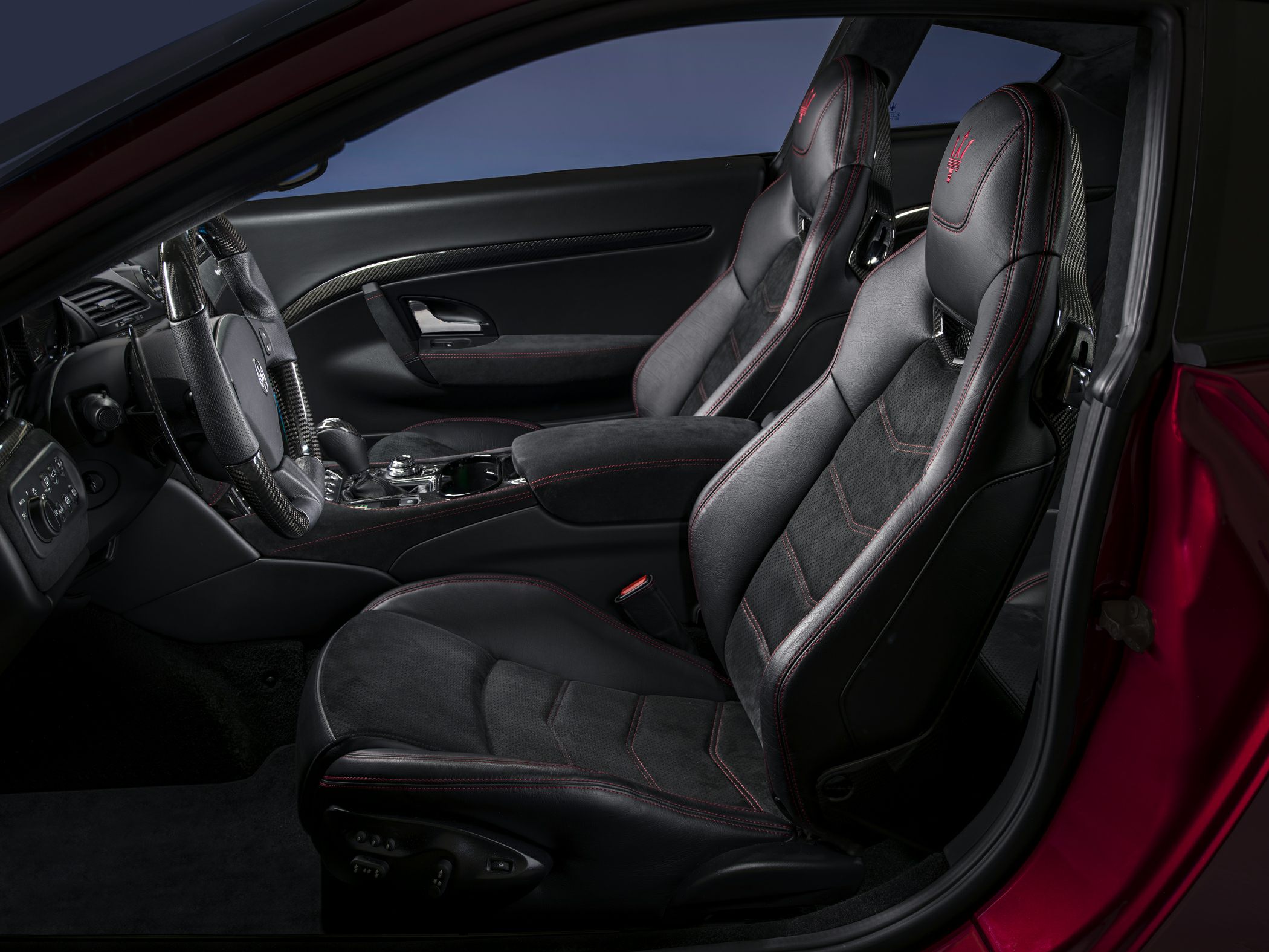 Sporty interior with carbon fiber trim and red-stitched sport seats